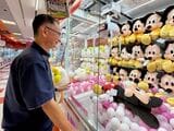 クレーンゲームに興じる小山さん（写真：筆者撮影）
