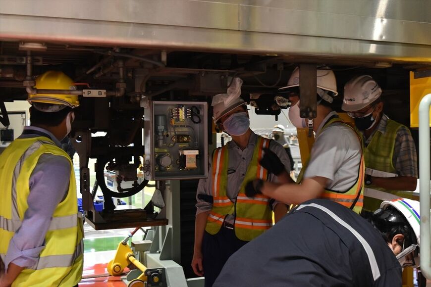 駐車ブレーキ制御装置の電磁弁交換を前に打ち合わせする専門家（筆者撮影）