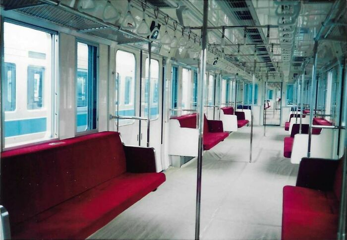 折りたたみ式座席と通路の手すりが目立つ登場時の車内。