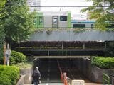 田町駅付近の「雑魚場架道橋」を走る京浜東北線と山手線。この付近では明治期の鉄道遺構「高輪築堤」の石積が見つかった（記者撮影）