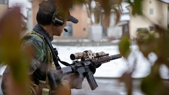  銃を持って狙いを定める男性