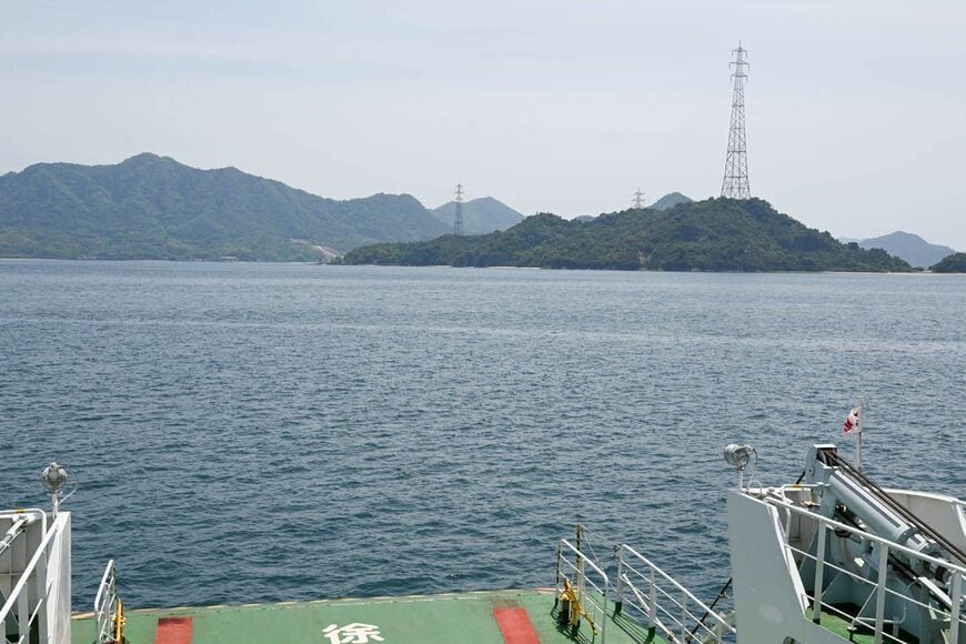 フェリーから見た瀬戸内海。ひときわ高い鉄塔のある島が、大久野島だ