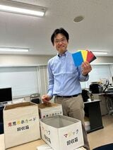 授業への主体的な参加を促す仕掛けを説明する岡田氏。学生はカード型のリアクションペーパーを使って意思表示をする（写真：筆者撮影）