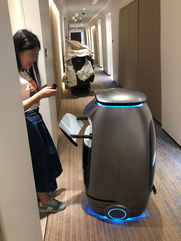 部屋に備え付けのAIスピーカー「Tモールジニー」に頼んだものは、もの運びロボット（天猫精霊福袋）が部屋まで持ってきてくれる（写真：筆者撮影）