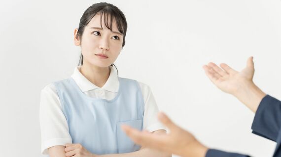 イラっとした表情で話を聞く介護スタッフ