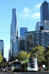 モダンな高層ビルが立ち並ぶ地区を行くフランス製と国産トラム（筆者撮影）