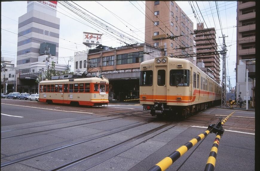 伊予鉄道の名所、市内線と郊外線が直交するクロッシングを行く700系（撮影：南正時）