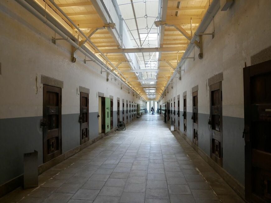 遺構として刑務所時代のまま保存されている、独居房が並ぶ長い廊下（写真：編集部撮影）