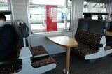 北海道をイメージできるモケットを使ったボックス席には、道産木材を使用したテーブルが設置されている（筆者撮影）