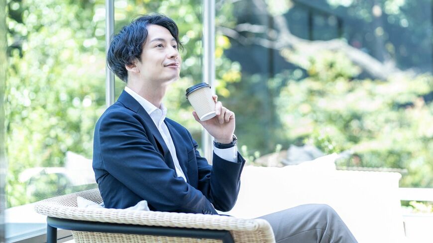 カフェのテラスで休憩するビジネスマン