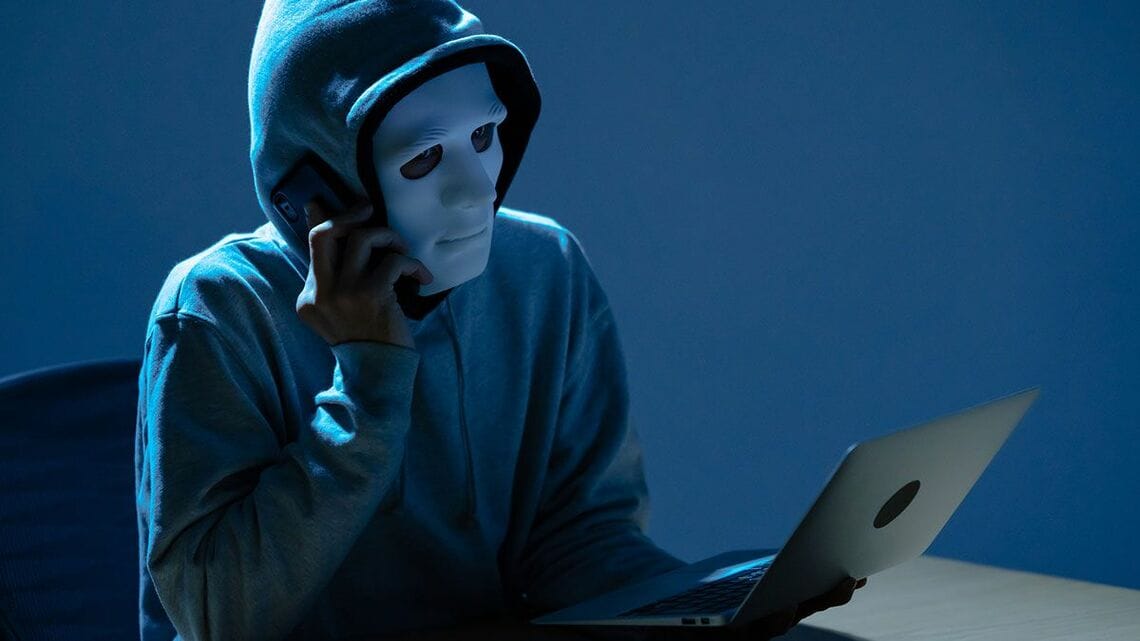 サイバー攻撃者が電話で人をだまそうとしているイメージ