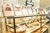 商品を出している店舗のシェフオーナーの写真もディスプレーされており、どの人がどんなパンを作っているのかわかる（撮影：大澤 誠）