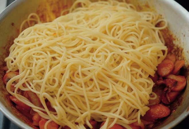 ゆでたスパゲッティを投入し、全体を絡めて、1分ほど炒める（筆者撮影）