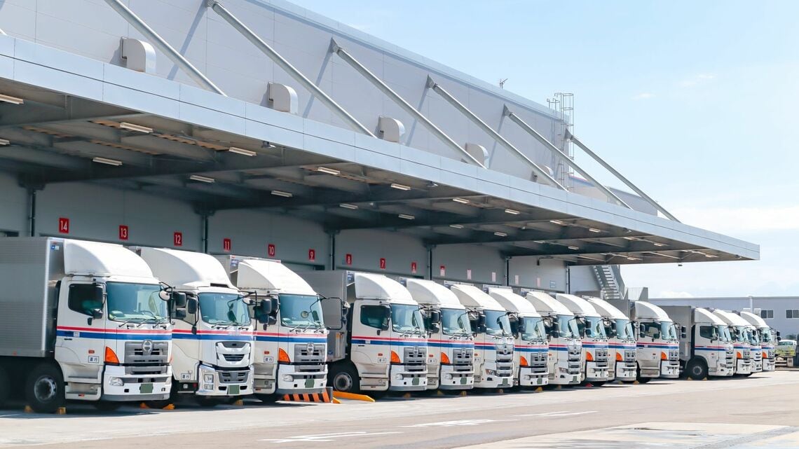 トラックが並ぶ物流倉庫